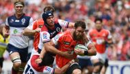 Sunwolves' lock Grant Hattingh (R) is tackled by Reds' centre Chris Feauai-Sautia (C) during the Round 13 Super Rugby match between the Sunwolves of Japan and the Reds of Australia at Prince Chichibu Memorial Stadium in Tokyo on May 12, 2018. / AFP / Mart