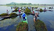 Boatmen manually remove weeds from Nageen Lake in Srinagar May 16, 2018. Reuters/Danish Ismail