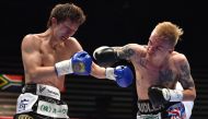 :South Africa's Hekkie Budler (R) punches Japan's Ryoichi Taguchi during their IBF, WBA world light flyweight unification title boxing bout in Tokyo on May 20, 2018. / AFP / Kazuhiro NOGI 