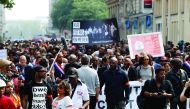 People hold a banner reading 