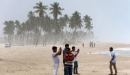 Omanis take pictures on the beach as high waves break along the shore in the southern city of Salalah on May 24, 2018 as the country prepares for landfall of Cyclone Mekunu.  AFP / Mohammed Mahjoub