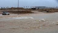 A picture taken on May 25, 2018, shows a car driving through a flooded street in the southern city of Salalah as the country prepares for landfall of Cyclone Mekunu. AFP / Mohammed Mahjoub