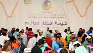 Fasting people having Iftar meals at HBJ Foundation tent.