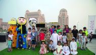 Children pose for photo with mascots at the Meerat Ramadan at Katara.