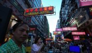 Buskers perform along Sai Yeung Choi street in the Mong Kok area of Hong Kong on May 26, 2018. The road, which has been a pedestrian zone on the weekends for 18 years, will be cleared in the coming weeks of all street performers and shoppers and opened up