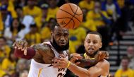 Golden State Warriors guard Stephen Curry (30) and Cleveland Cavaliers forward LeBron James (23) go for a loose ball during the second quarter in game one of the 2018 NBA Finals at Oracle Arena.  Kyle Terada