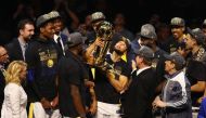 Stephen Curry #30 of the Golden State Warriors celebrates with the Larry O'Brien Trophy after defeating the Cleveland Cavaliers during Game Four of the 2018 NBA Finals at Quicken Loans Arena on June 8, 2018 in Cleveland, Ohio. Justin K. Aller/Getty Images