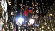 A Russia's national football team fan stands on a lamp post as he celebrates their team's victory outside the Kremlin after the Russia 2018 World Cup Group A football match between Russia and Egypt at the Saint Petersburg Stadium in Saint Petersburg on Ju