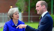 Britain's Prime Minister Theresa May talks with Britain's Prince William during the official handover to the nation of the newly built Defence and National Rehabilitation Centre (DNRC) at the Stanford Hall Estate, Loughborough, Britain, June 21, 2018. Oli