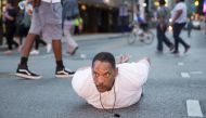 A man lays on the ground after yelling 'Don't shoot me' at police during a rally in Dallas, Texas on July 7, 2016 to protest the deaths of Alton Sterling and Philando Castile (AFP) 