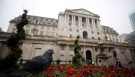 FILE PHOTO: A pigeon stands in front of the Bank of England in London, Britain, April 9, 2018. REUTERS/Hannah McKay/File Photo