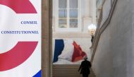 An employee of the constitutional council climbs stairs on June 19, 2018 in the constitutional council in Paris.  AFP / Joel Saget

