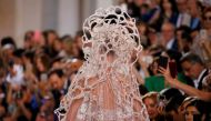 A model presents a wedding dress by designer Elie Saab as part of his Haute Couture Fall/Winter 2018/2019 fashion show in Paris, France, July 4, 2018. Reuters/Regis Duvignau