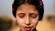 A Rohingya refugee girl named Amina poses for a photograph as she wears thanaka paste at Kutupalong camp in Cox's Bazaar, Bangladesh, March 30, 2018. Reuters/Clodagh Kilcoyne