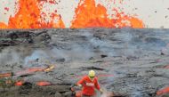 A geologist is collecting sample of molten lava from 2011 Kamoamoa eruption, at Kilauea Volcano, Hawaii, U.S.  USGS/Handout via Reuters