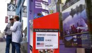 FILE PHOTO: A travel agent on the Royal Mile offers a currency exchange service in Edinburgh on June 25, 2016 following the pro-Brexit result of the EU referendum vote (AFP) 