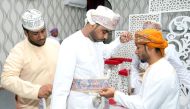 Omani grooms dress up ahead of a mass wedding ceremony of 24 couples in Al-Mudhaibi province on July 20, 2018. AFP / Mohammed Mahjoub