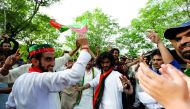 Supporters of cricket star-turned-politician Imran Khan, chairman of Pakistan Tehreek-e-Insaf (PTI), celebrate outside his residence in Islamabad, Pakistan, a day after polling in the general election, July 26, 2018. Reuters/Faisal Mahmood