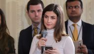 In this file photo taken on February 13, 2017 The Daily Caller White House correspondent Kaitlan Collins (Mic in hand) asks a question during a press conference by US President Donald Trump and Canada's Prime Minister Justin Trudeau in the East Room of th