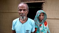 Abdul Suban, a farmer, and his wife pose for a photograph outside their home in Nellie village, in Morigaon district, in the northeastern state of Assam, India July 25, 2018. Picture taken July 25, 2018. Reuters