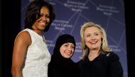 Former US Secretary of State Hillary Clinton and then First lady Michelle Obama congratulate Samar Badawi of Saudi Arabia during the State Department's 2012 International Women of Courage Award winners ceremony in Washington March 8, 2012. (REUTERS/Gary C