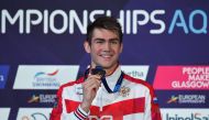 Gold medallist Russia's Kliment Kolesnikov poses on the podium during the medal ceremony for the Men's 50m backstroke swimming final at the Tollcross swimming centre during the 2018 European Championships in Glasgow on August 4, 2018. (AFP / Oli SCARFF)