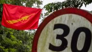 A student flag, known as the Fighting Peacock flag, which was used during the 1988 student protests, is hung at the main entrance of the University of Yangon during a gathering to mark the 30th anniversary of the uprising in Yangon on August 8, 2018. AFP 