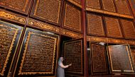 People visit the Bayt Al Quran Al Akbar Museum in Palembang, Indonesia on August 5, 2018. Parts of Holy Quran were beautifully carved on the 1,77 x 1,4 meters wide and 2,5 cm thick Tembesu wood at the 5-storey building. (Muhammad AF/ Anadolu Agency)