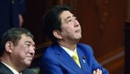 In this file photo taken on July 16, 2015 Japan's Prime Minister Shinzo Abe (R) and then Regional Revitalization Minister Shigeru Ishiba (L) listen to a speech by a member of an opposition party at the parliament in Tokyo.  AFP / Kazuhiro Nogi
 