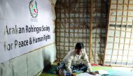 Mohib Bullah, a member of Arakan Rohingya Society for Peace and Human Rights, writes after collecting data about victims of a military crackdown in Myanmar, at Kutupalong camp in Cox's Bazar, Bangladesh, April 21, 2018.  Reuters/Mohammad Ponir Hossain 