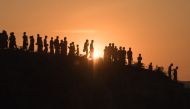 In this file photo taken on November 26, 2017 Rohingya Muslim refugees walk down a hillside in the Kutupalong refugee camp in Bangladesh. AFP / Ed Jones 