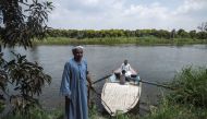 Workers in a mango farms ride a boat on a branch of the Nile, after finishing their work in the Al Qata village, Giza Governorate on August 27, 2018. / AFP / Mohamed el-Shahed 