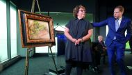 Sylvie Sulitzer stands with Geoffrey S. Berman (L), the United States Attorney for the Southern District of New York after unveiling the painting Deux Femmes Dans Un Jardin by Pierre Auguste Renoir during a ceremony to return the painting, stolen by the N