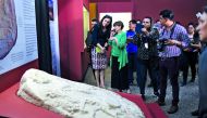 People look at a Mayan altar exhibited at the National Museum of Archaeology and Ethnology in Guatemala City on September 12, 2018. AFP / Johan Ordonez


