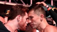 In this file photo taken on September 14, 2018 pro boxer Canelo Alvarez (L) and WBC/WBA middleweight champion Gennady Golovkin are held back after facing off during their official weigh-in at T-Mobile Arena in Las Vegas, Nevada. / AFP / GETTY IMAGES NORTH