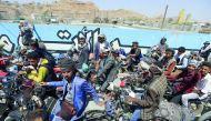 Yemeni motorcyclists wait in line to buy fuel at a petrol station amid fuel shortages in the capital Sanaa, on September 17, 2018. AFP / Mohammed Huwais
