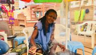 Christelle Timdi grilling fish at her stall in Yaounde, Cameroon on August 23, 2018. Thomson Reuters Foundation / Inna Lazareva