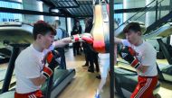 A young boxer is reflected in a mirror as he trains with a punching bag at the re-opening of the Dale Youth Amateur Boxing Club, which was gutted in the 2017 Grenfell Tower fire that killed 71 people, in west London on September 28, 2018. AFP / Tolga Akme