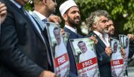 Protestors hold pictures of missing journalist Jamal Khashoggi during a demonstration in front of the Saudi Arabian consulate, on October 5, 2018 in Istanbul.  AFP / Ozan Kose 