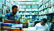 Iraqi men check a shop at the Howeish book market in the holy city of Najaf, 150 kilometres (95 miles) south of Baghdad, on August 16, 2018. AFP / Haidar Hamdani