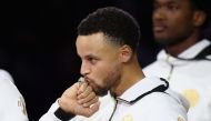 Stephen Curry #30 of the Golden State Warriors kisses his 2017-2018 Championship ring prior to their game against the Oklahoma City Thunder at ORACLE Arena on October 16, 2018 in Oakland, California. Ezra Shaw/Getty Images/AFP