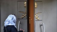 A Saudi citizen stands at the entrance of the Saudi Arabian Consulate as she speaks to a person inside on October 17, 2018 in Istanbul.  AFP / OZAN KOSE