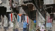 A man stands in a street near destroyed buildings in the Palestinian camp of Yarmuk southern Damascus on November 1, 2018.   AFP / LOUAI BESHARA