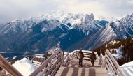 Henry and Silas Walker stroll along the Sulphur Mountain Boardwalk, which takes visitors on a ridgeline walk and delivers 360-degree views of the Bow River Valley. Rachel Walker / The Washington Post 
