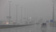 Cars put on their lights as they drive through rain and mist in Kuwait City in stormy weather on November 14, 2018, four days after flash floods hit the Gulf emirate, killing a man and causing damage to roads, bridges and homes. / AFP / Yasser Al-Zayyat