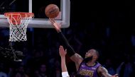 LeBron James #23 of the Los Angeles Lakers scores over Evan Turner #1 of the Portland Trail Blazers during a 126-117 Laker win at Staples Center on November 14, 2018 in Los Angeles, California. Harry How/AFP 