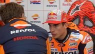 Repsol Honda's Spanish rider Marc Marquez speaks with a mechanic in the box during the fourth MotoGP free practice session of the Valencia Grand Prix at the Ricardo Tormo racetrack in Cheste on November 17, 2018. / AFP / JOSE JORDAN