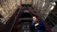 Polish carillon player Malgosia Fiebig poses for a picture below the bells of the Dom Tower (Domtoren) in Utrecht, the Netherlands' tallest church tower, on November 8, 2018. AFP / JOHN THYS