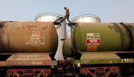 A worker walks atop a tanker wagon to check the freight level at an oil terminal on the outskirts of Kolkata November 27, 2013. REUTERS/Rupak De Chowdhuri/File Photo