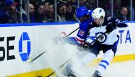 Winnipeg Jets right wing Patrik Laine (29) and New York Rangers defenseman Marc Staal (18) battle for the puck behind the goal during the third period at Madison Square Garden. Credit: Dennis Schneidler-USA Today Sports 